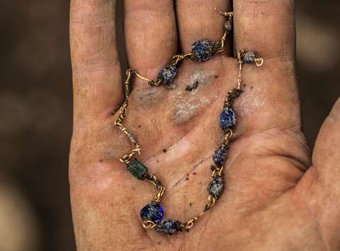 A golden necklace with glass beads. The item was discovered in one of the simple 4th-century graves.