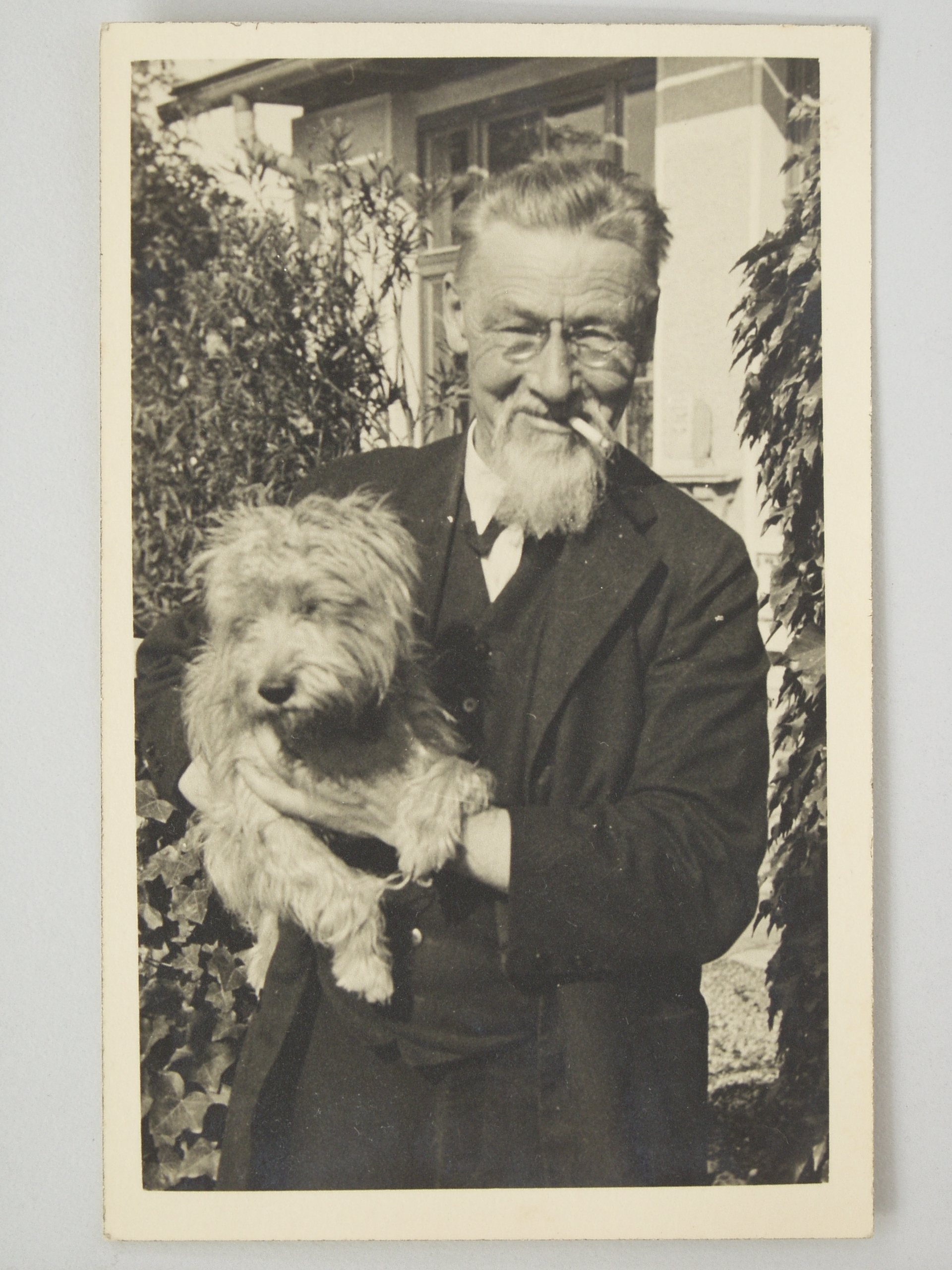 Plečnik with his dog Sivko, in front of his house In Trnovo